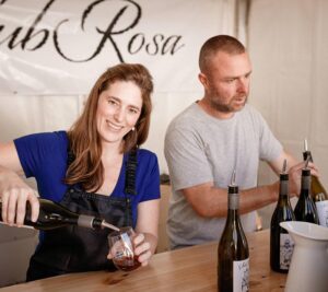 Nancy and Adam from SubRosa Wines pouring wine at a pop up event stall