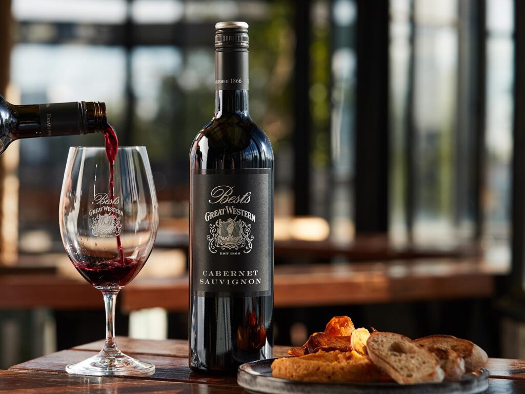 Bests Great Western Cabernet Sauvignon Bottle, glass of wine and plate of food